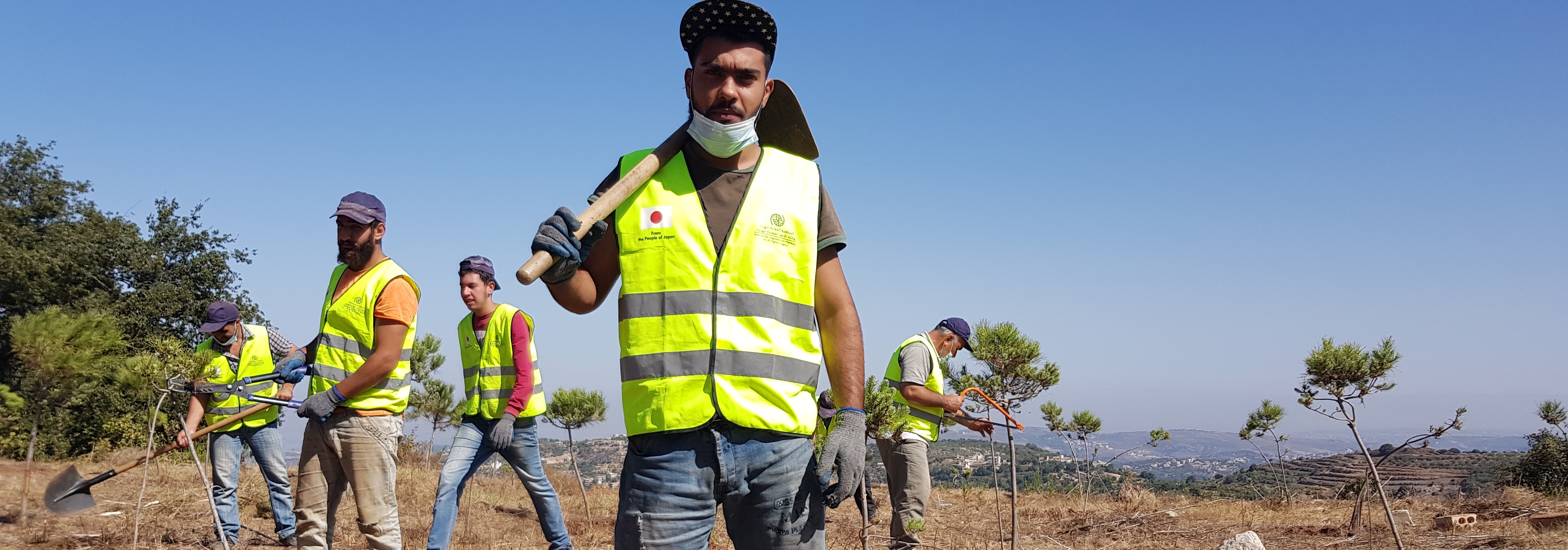 Beneficiaries carry out public gardening and tree-trimming in Hrar village, Akkar. @ IOM Lebanon, 2021