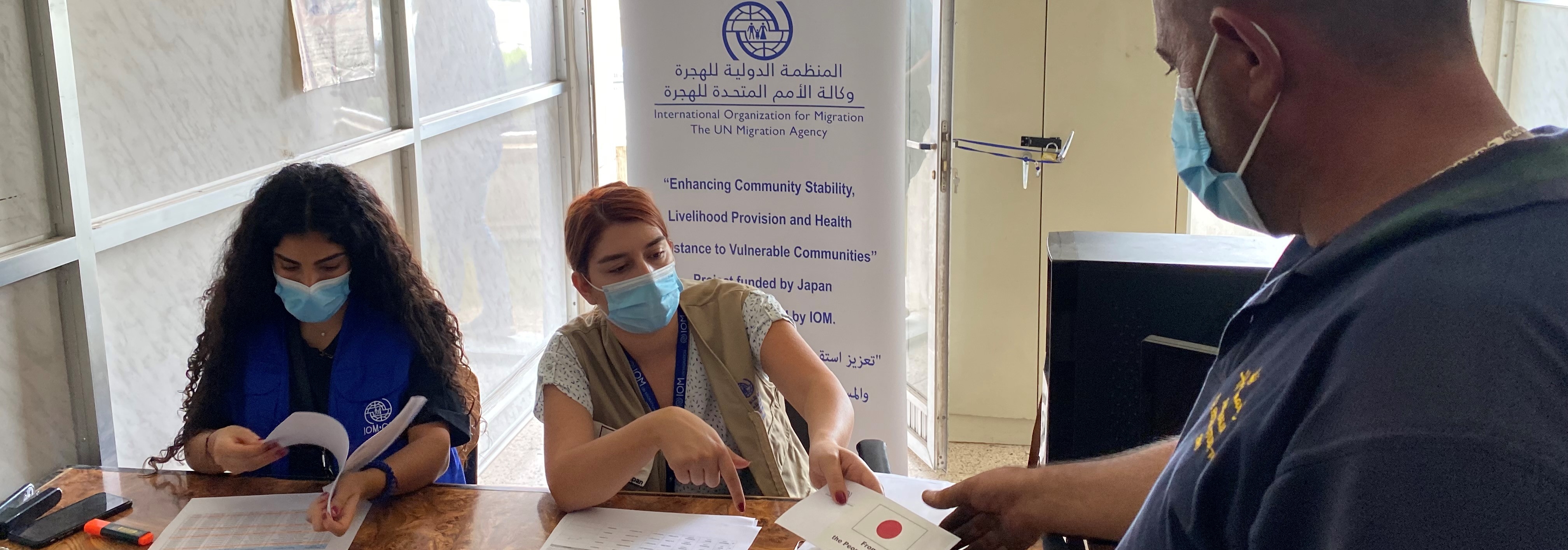 IOM field staff distribute livelihood assistance to beneficiaries in West Bekaa, Lebanon. @ IOM Lebanon, 2021 